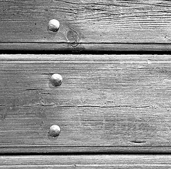 Image showing abstract texture of a brown antique wooden old door in italy   e