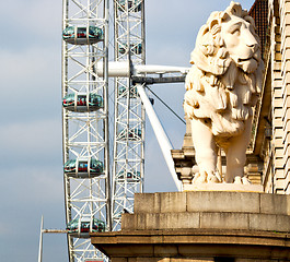 Image showing lion  london eye in the spring sky and white clouds