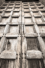 Image showing abstract texture of a brown antique wooden old door in italy   e