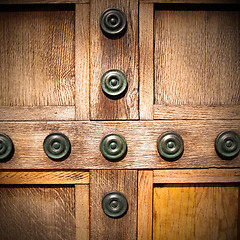 Image showing in london antique brown door  rusty  brass nail and light