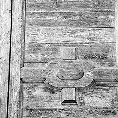 Image showing grain texture of a brown antique wooden old door in italy   euro