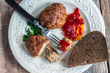 Image showing Turkey cutlets with sweet pepper jam closeup.