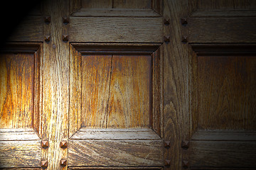 Image showing abstract texture of a brown antique wooden old door in italy   e