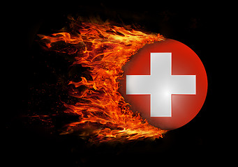 Image showing Flag with a trail of fire - Switzerland