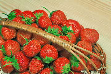Image showing Basket of strawberries on the table surface.
