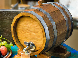 Image showing Wooden oak wine barrel with metal tap.