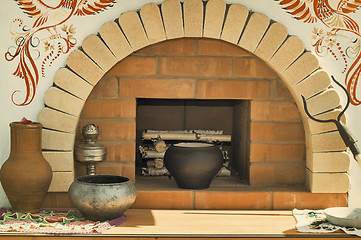 Image showing A model of an old stove and antique dishes.