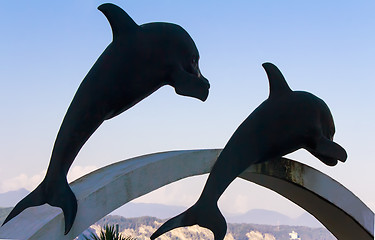 Image showing Sculptures of dolphins in the sky.