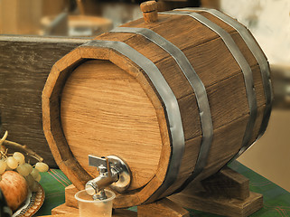 Image showing Wooden oak wine barrel with metal tap.