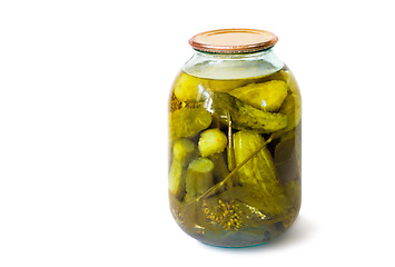 Image showing Home canning: glass cylinders with pickled cucumbers  on white b