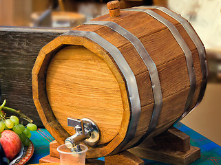 Image showing Wooden oak wine barrel with metal tap.