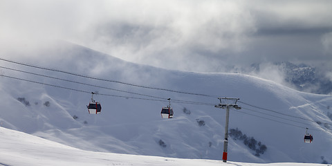 Image showing Panoramic view on gondola lifts and off-piste slope in mist