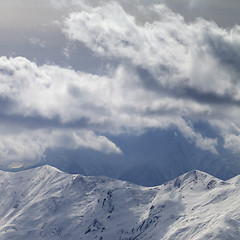 Image showing Evening mountains and sunlight cloudy sky