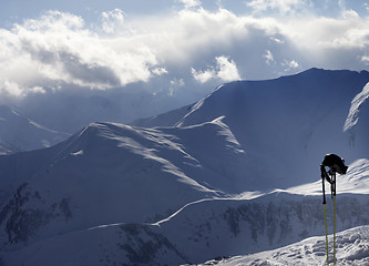 Image showing Evening sunlight mountains and ski equipment