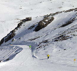 Image showing Snowboarders and skiers on groomed slope