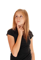 Image showing Young girl holding finger on chin.