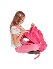 Image showing Surprised girl looking into her backpack.