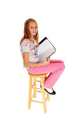 Image showing Schoolgirl sitting with her schoolbook.