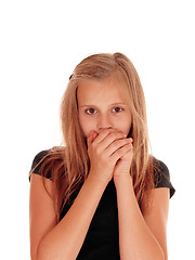 Image showing Young girl holding hands over mouth.