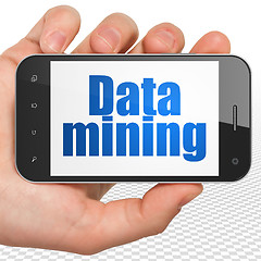 Image showing Data concept: Hand Holding Smartphone with Data Mining on display