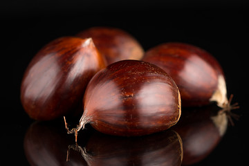 Image showing Chestnuts on a black reflective background