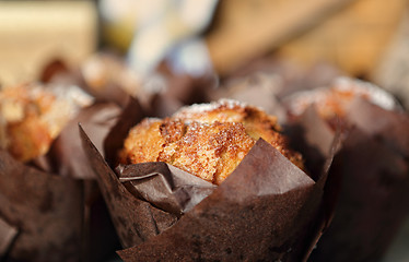 Image showing Fresh baked muffins lightly dusted with icing sugar