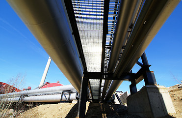 Image showing Industrial zone, Steel pipelines and valves against blue sky