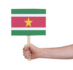 Image showing Hand holding small card - Flag of Suriname