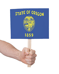 Image showing Hand holding small card - Flag of Oregon