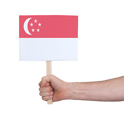Image showing Hand holding small card - Flag of Singapore
