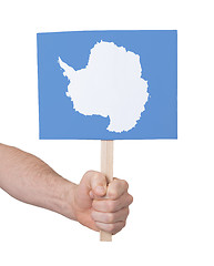 Image showing Hand holding small card - Flag of Antarctica