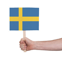 Image showing Hand holding small card - Flag of Sweden