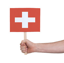 Image showing Hand holding small card - Flag of Switzerland