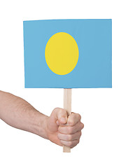 Image showing Hand holding small card - Flag of Palau