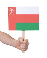 Image showing Hand holding small card - Flag of Oman