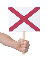 Image showing Hand holding small card - Flag of Alabama