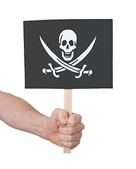 Image showing Hand holding small card - Flag of Pirate