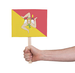 Image showing Hand holding small card - Flag of Sicily