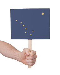 Image showing Hand holding small card - Flag of Alaska