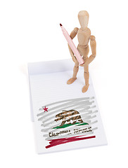 Image showing Wooden mannequin made a drawing - California