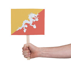 Image showing Hand holding small card - Flag of Bhutan