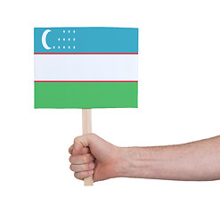 Image showing Hand holding small card - Flag of Uzbekistan