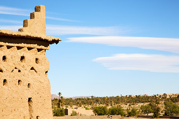 Image showing brown old  construction in  palm tree  near the tower