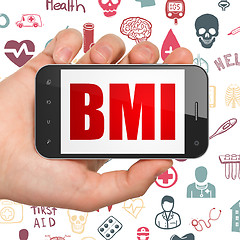 Image showing Medicine concept: Hand Holding Smartphone with BMI on display