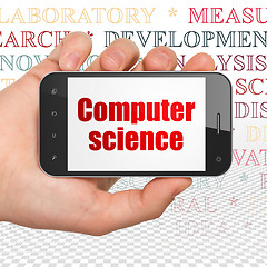 Image showing Science concept: Hand Holding Smartphone with Computer Science o