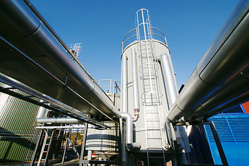 Image showing Industrial zone, Steel pipelines and valves against blue sky