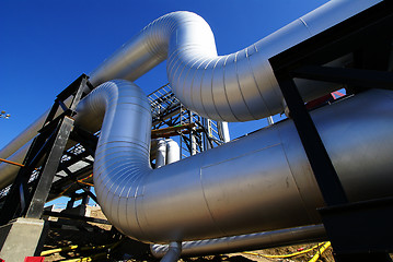 Image showing Industrial zone, Steel pipelines and valves against blue sky