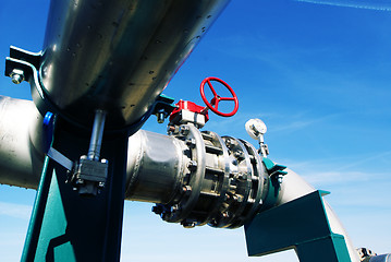 Image showing Industrial zone, Steel pipelines and valves against blue sky