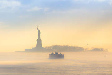 Image showing Staten Island Ferry cruises past Statue of Liberty.