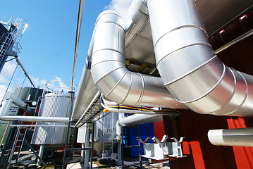 Image showing Industrial zone, Steel pipelines and valves against blue sky